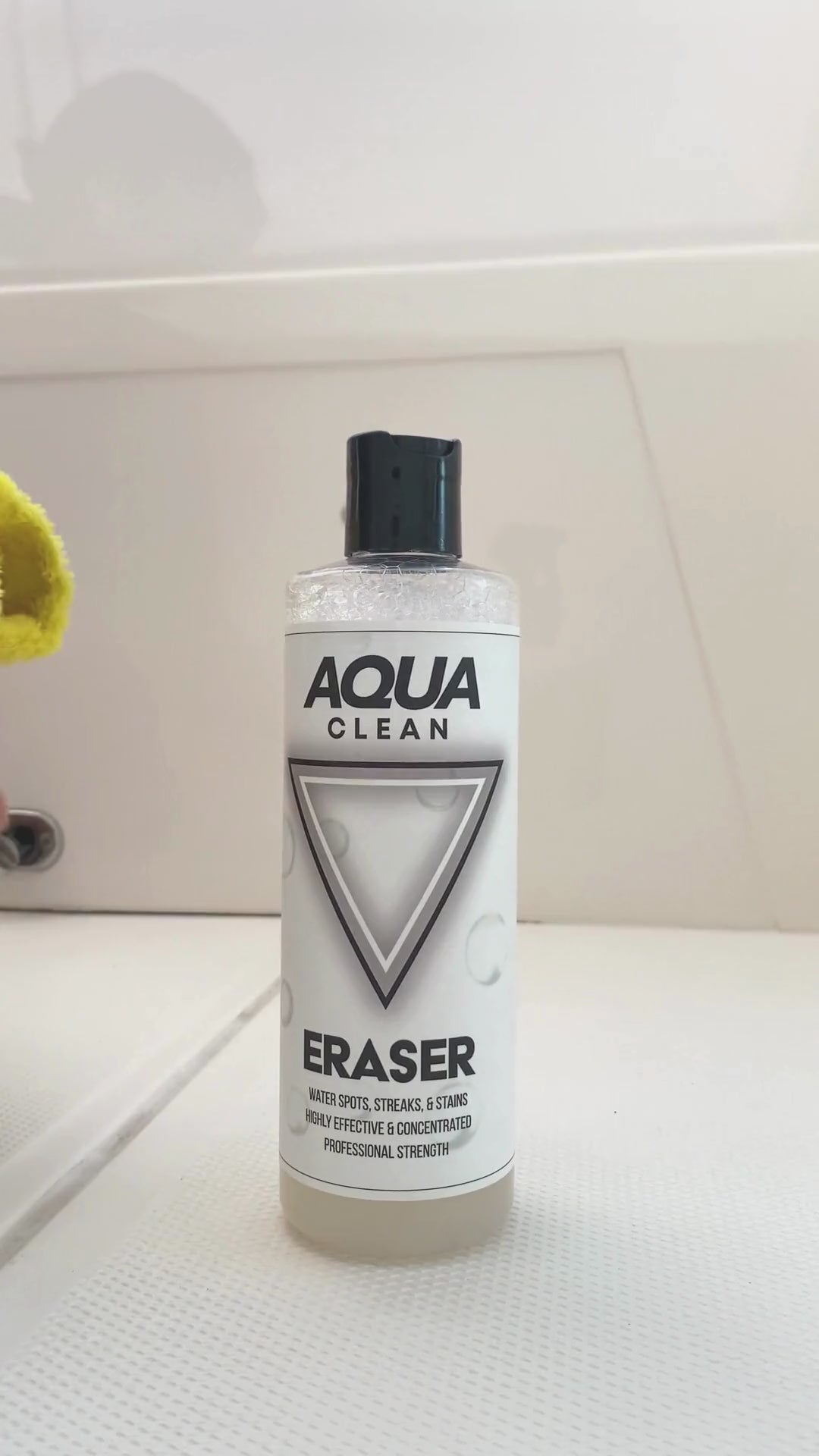 Video showcasing AquaClean Eraser stain removal product bottle on white surface